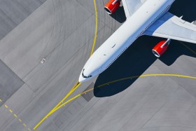 Aircraft on runway with yellow lines